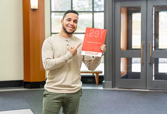 An image of a student holding an appendance packet. 